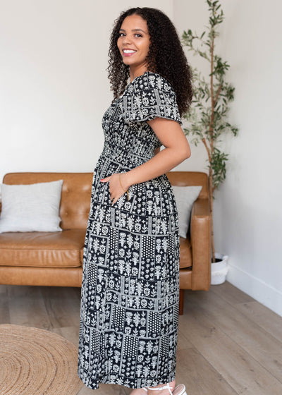 Side view of the black printed smocked dress