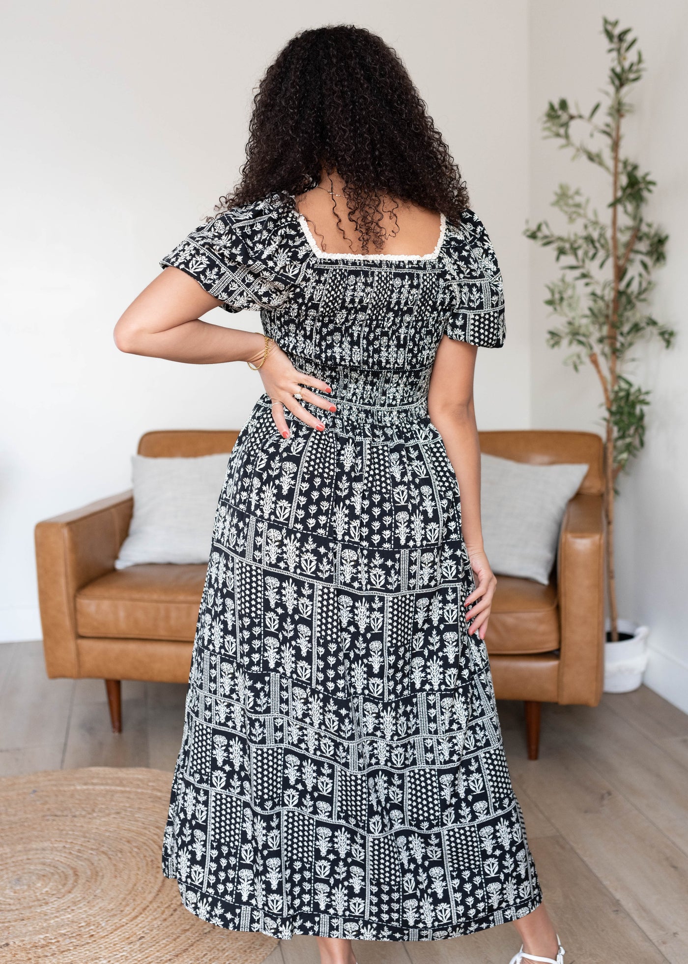 Back view of the black printed smocked dress