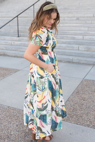 Side view of the green tropical print dress with pockets