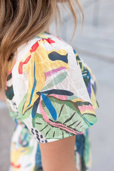 Close up of the sleeve and fabric on the green tropical print dress
