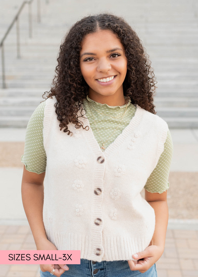 Close up of the cream floral knit vest