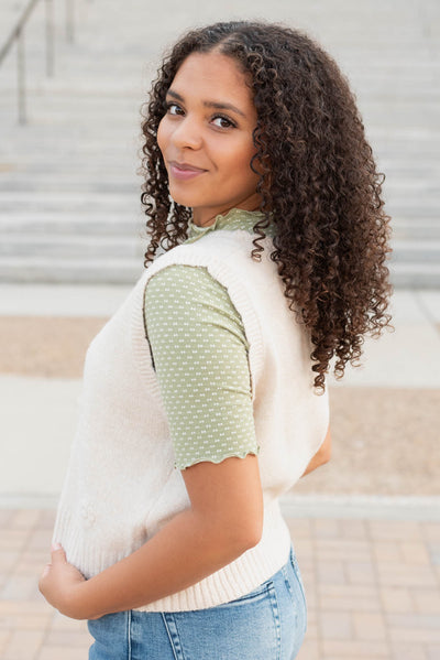 Side view of the cream floral knit vest