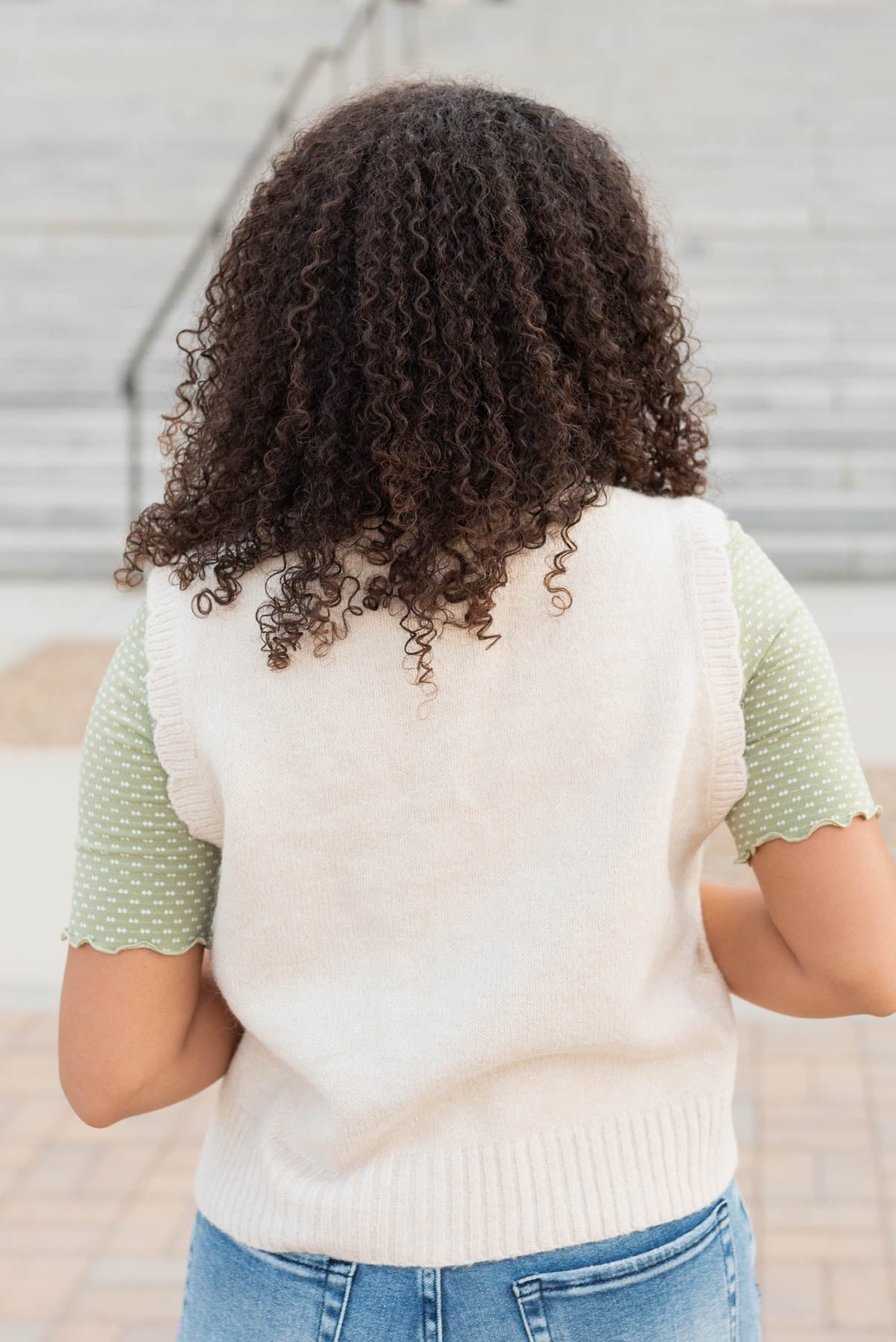 Back view of the cream floral knit vest