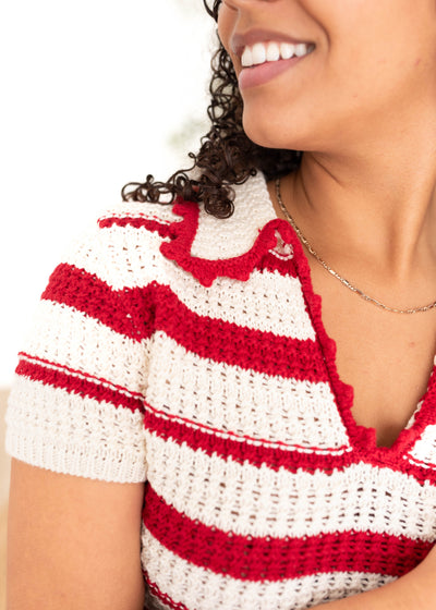 Close up of the knit on the white and red knit sweater vest