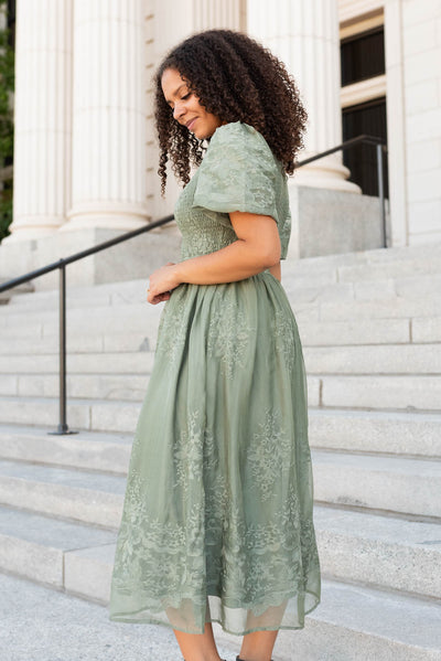 Side view of the deep sage embroidered dress