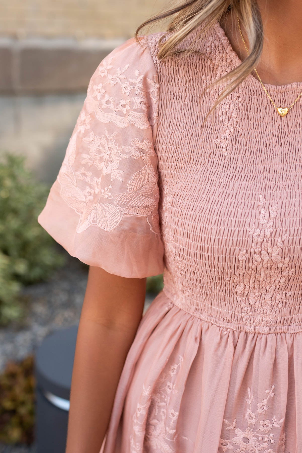 Close up of the fabric and sleeve on the dusty pink embroidered dress