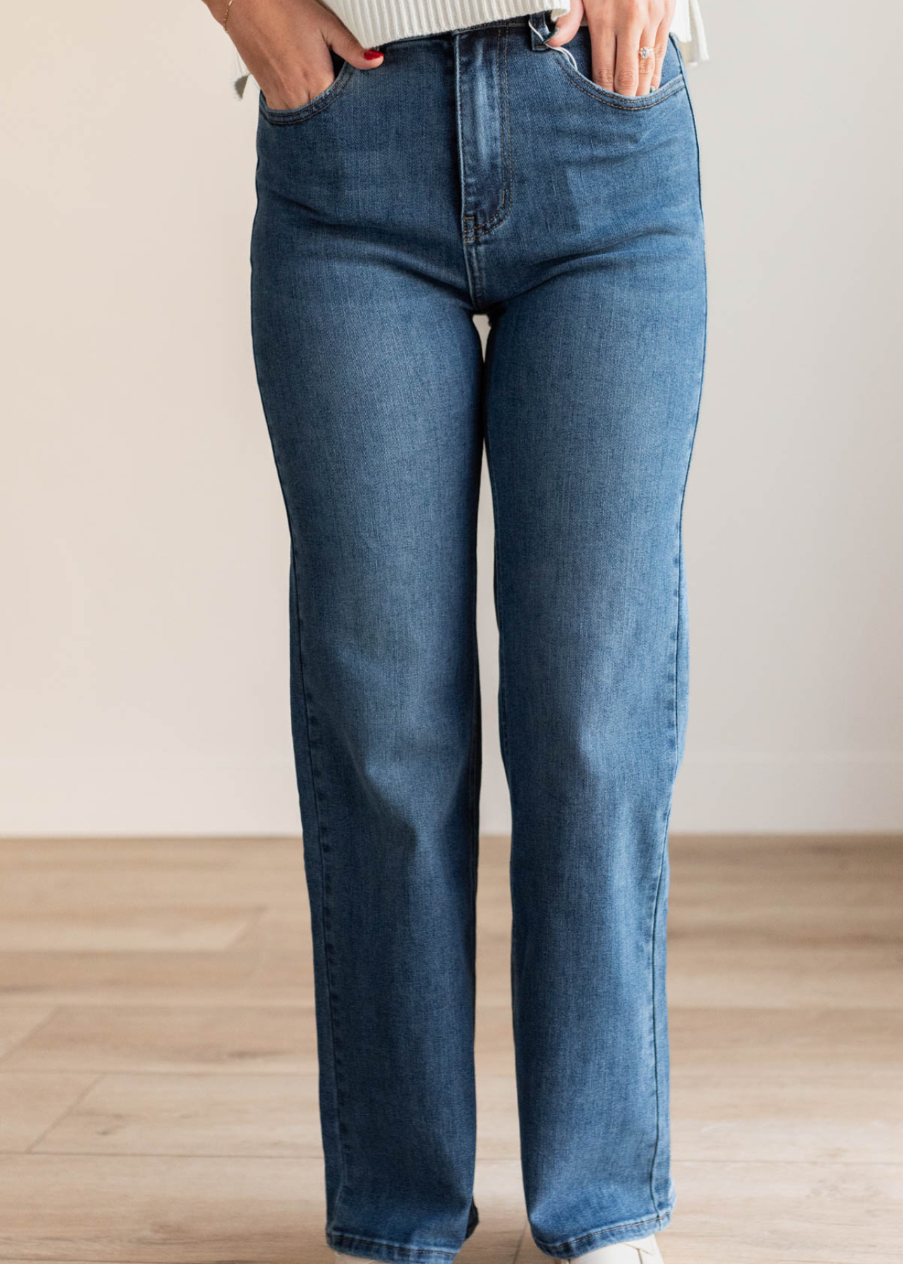 Close up of the medium wash high rise straight jeans