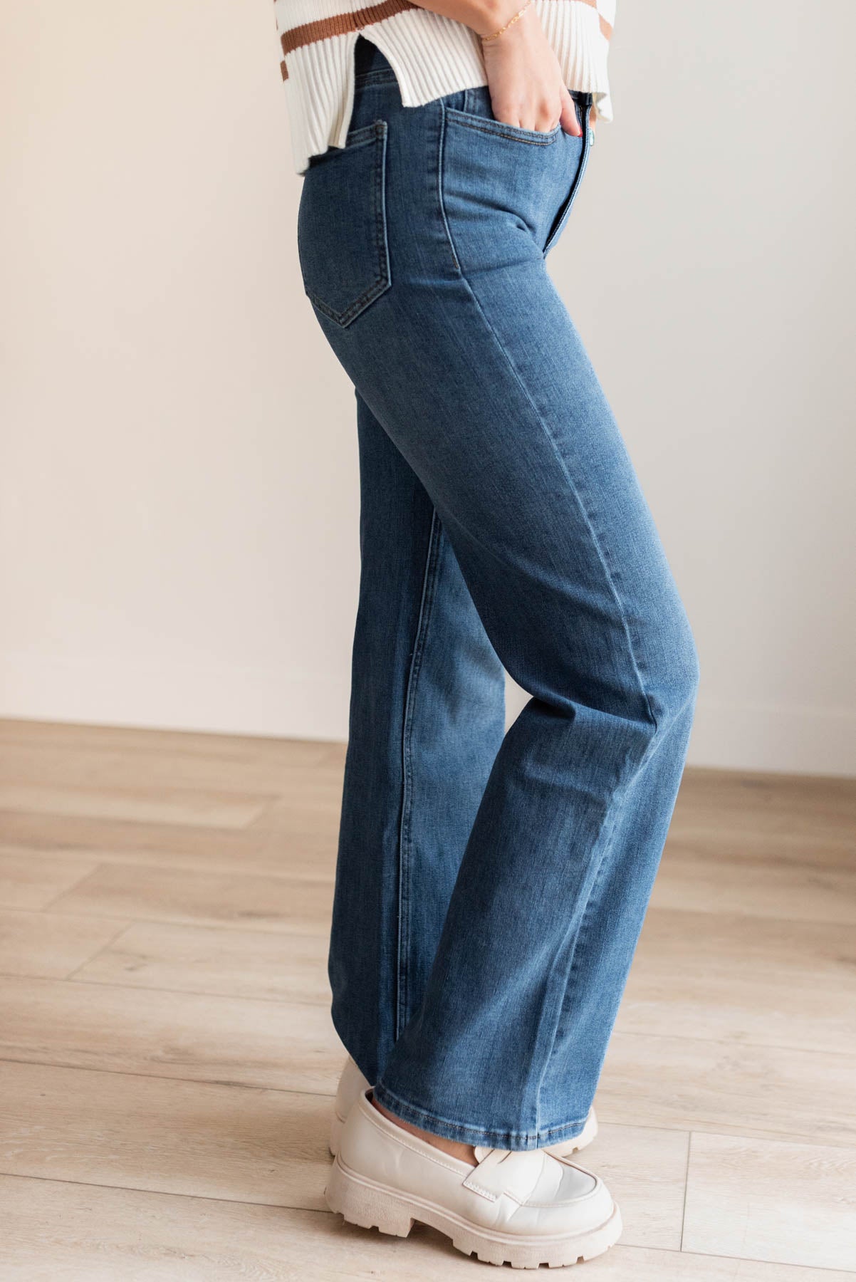 Side view of the medium wash high rise straight jeans