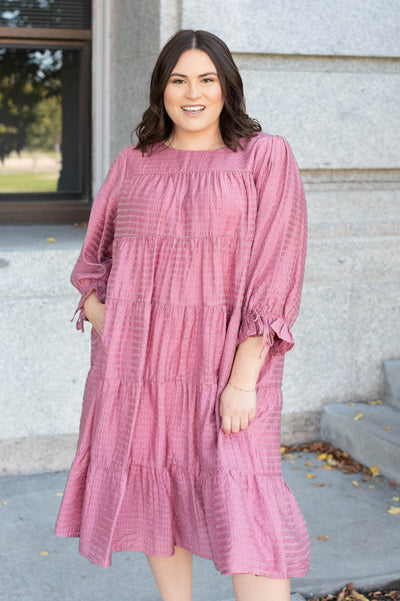 Plus size pink long sleeve dress with bows on the cuffs