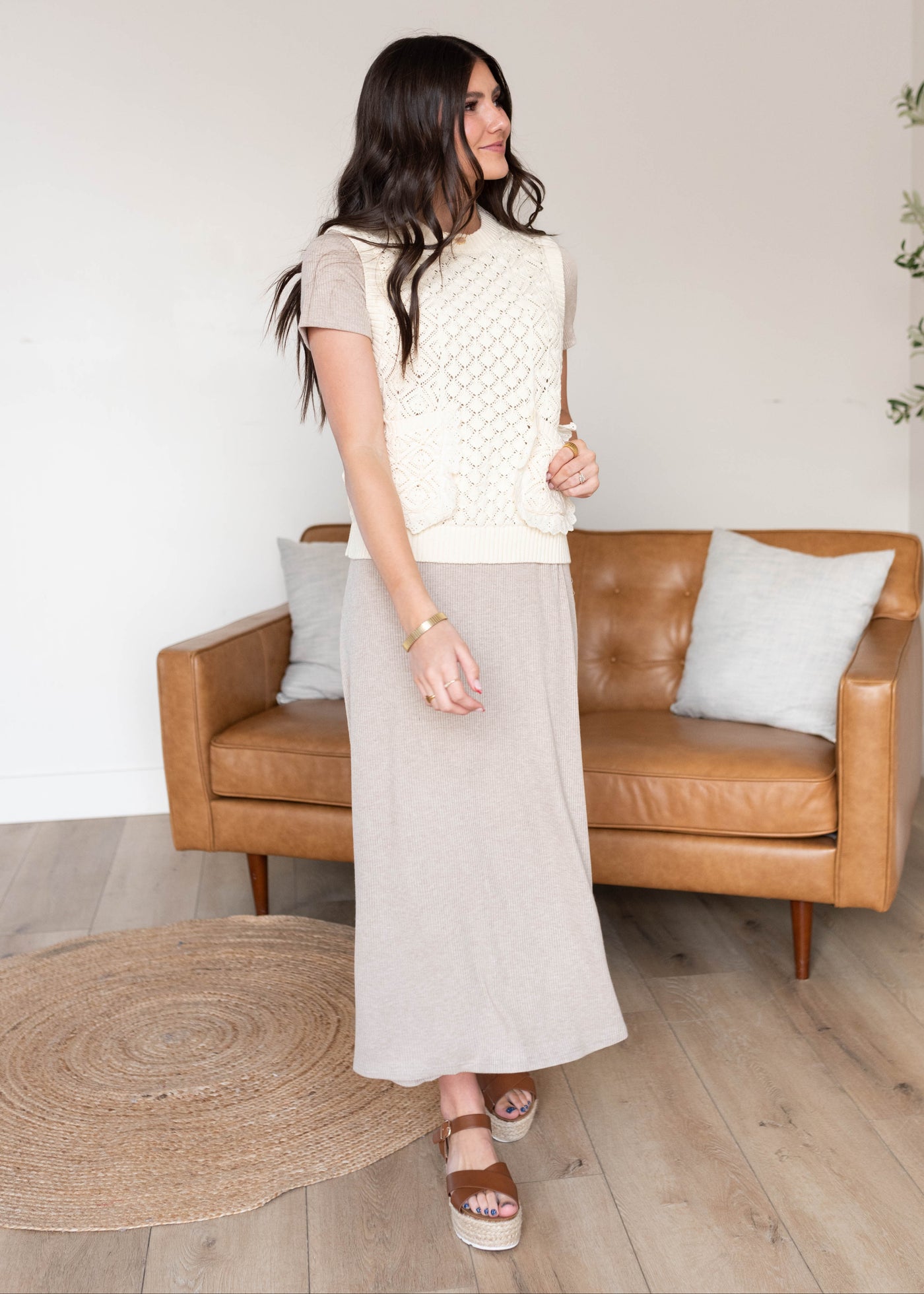 Small cream knit sweater vest with front pockets