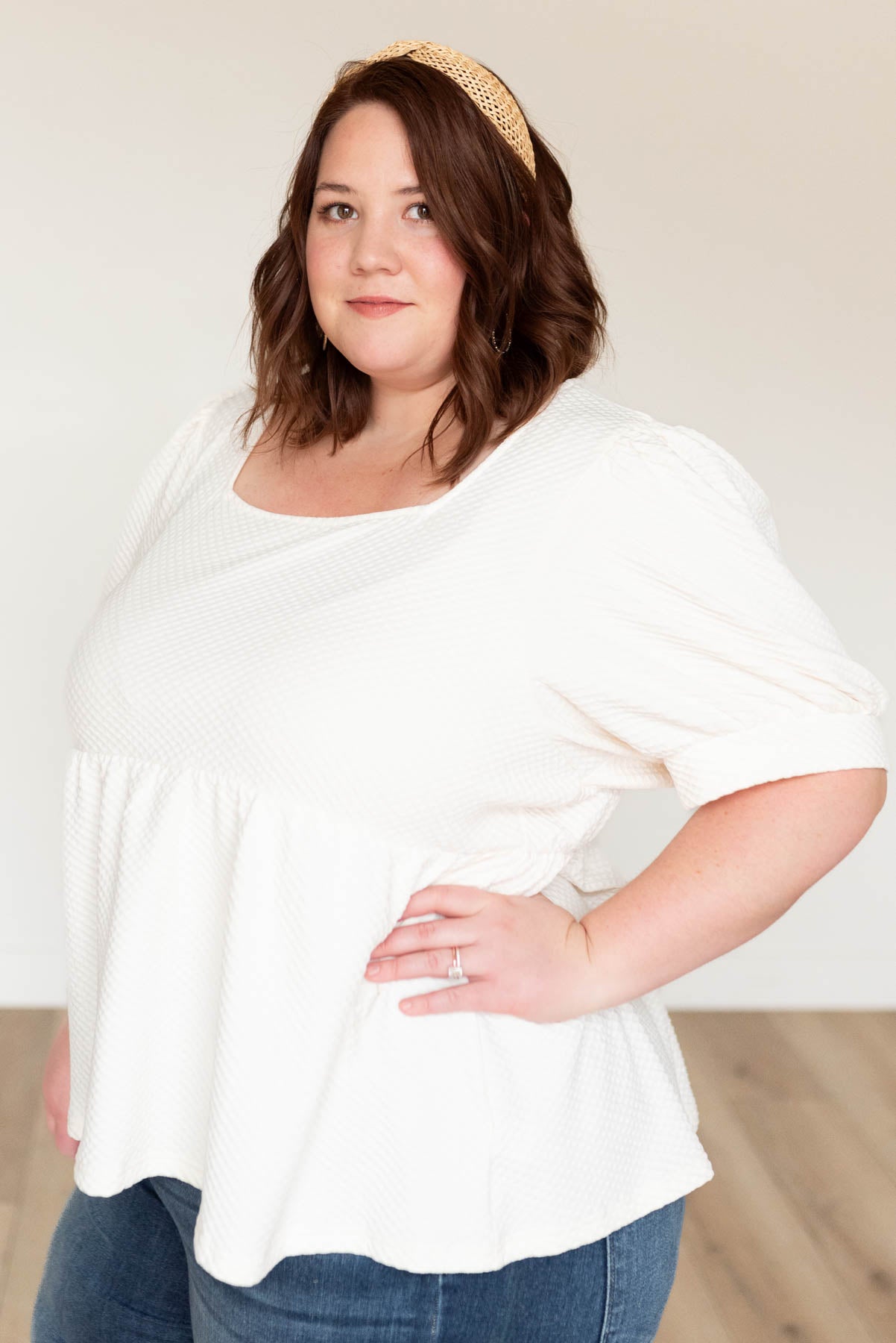 Side view of the cream ruffle top