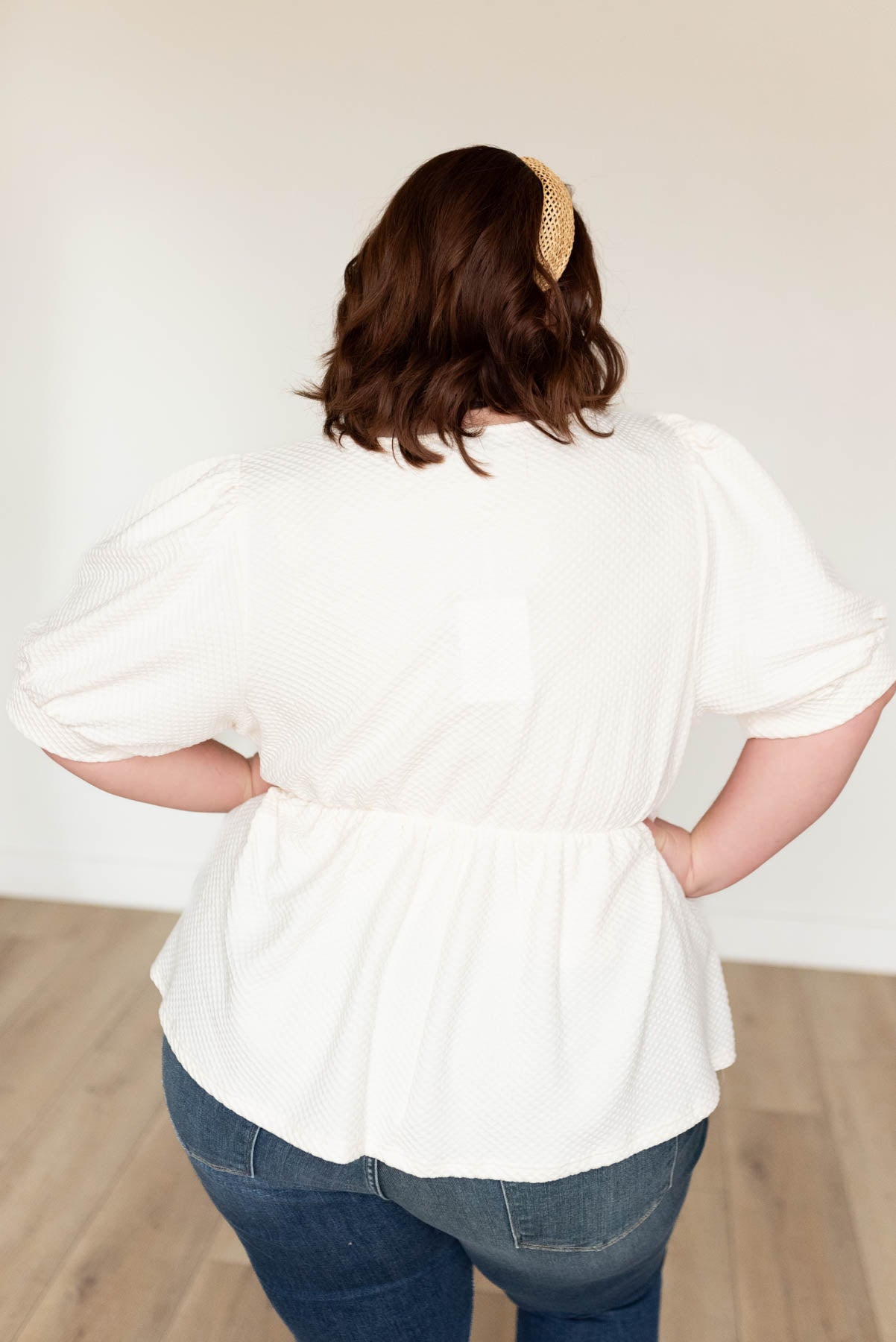 Back view of the plus size cream ruffle top