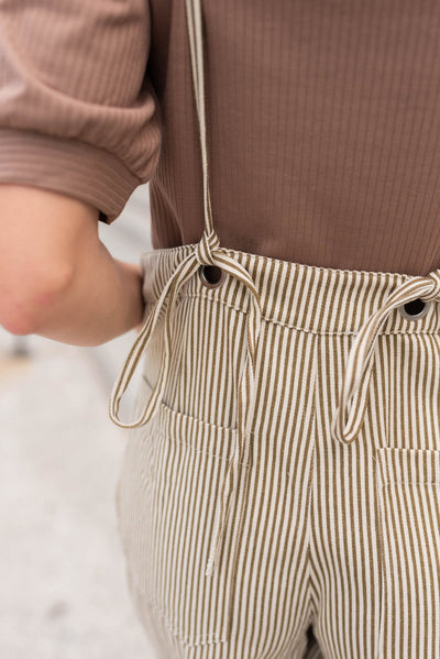 Close up of the back ties on the olive stripe overalls