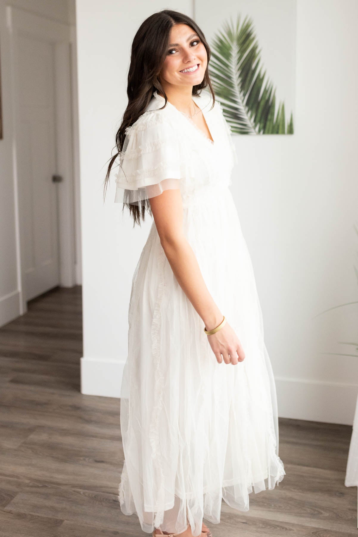 Side view of the small cream sheer ruffle dress