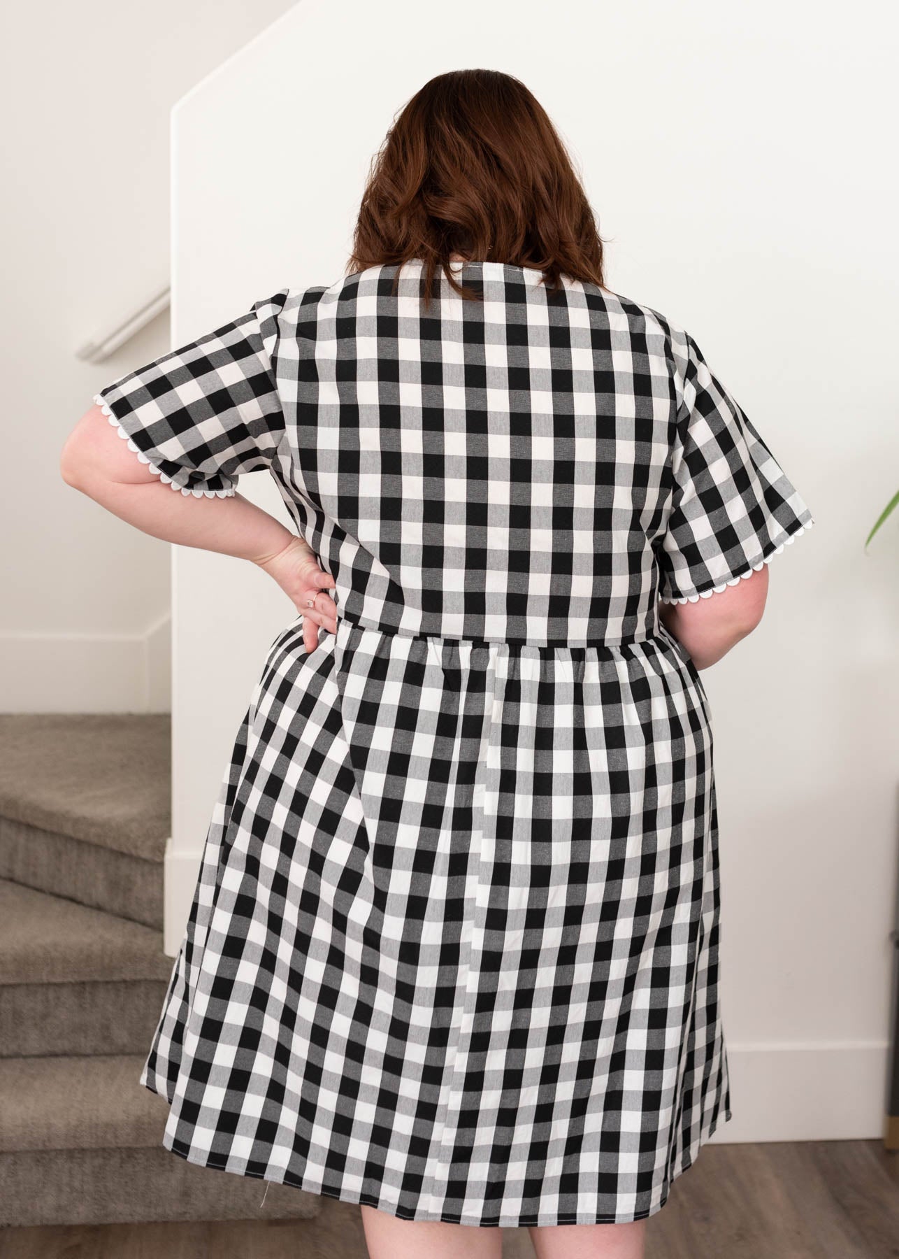 Back view of the black gingham button dress in plus size