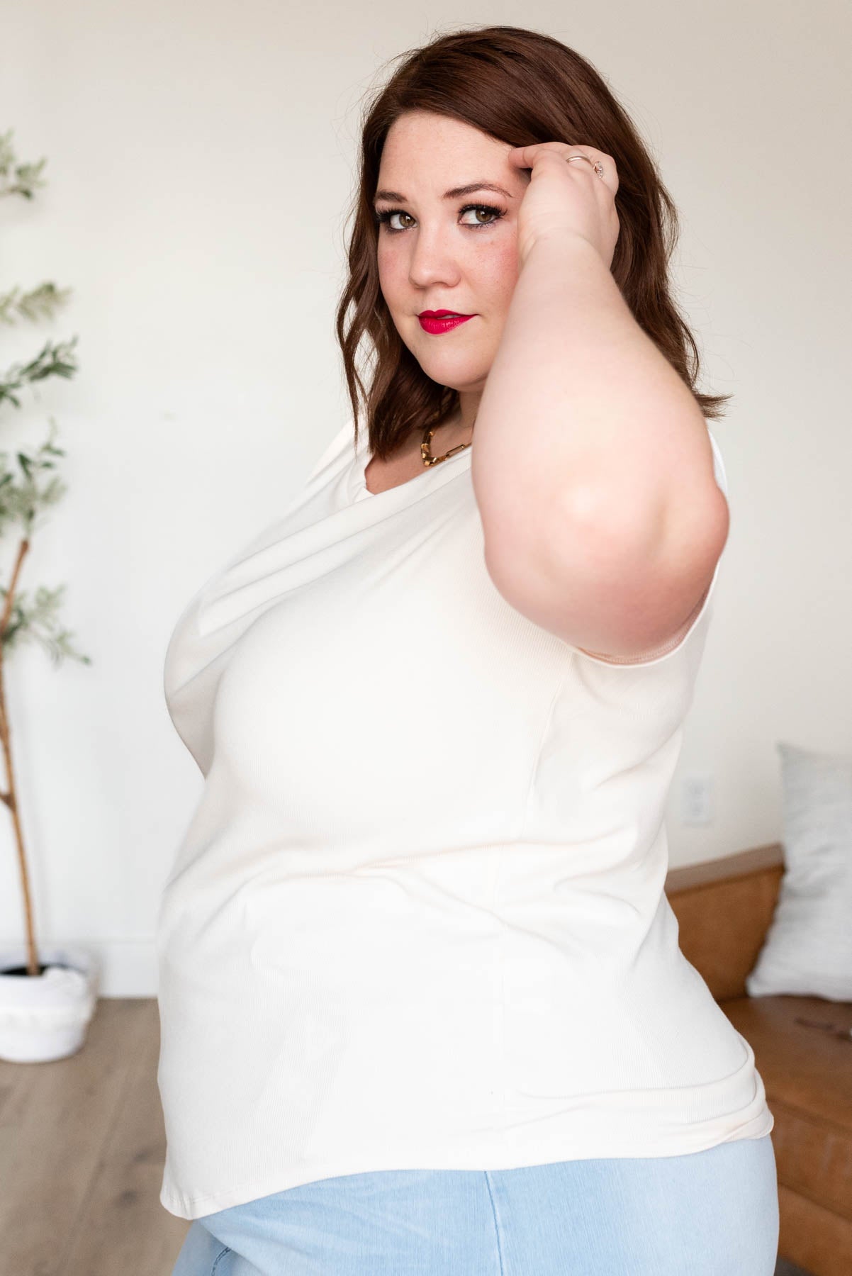 Side view of the plus size cream ribbed top