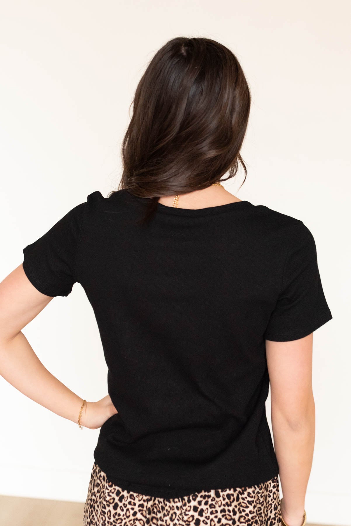 Back view of the black ribbed top with short sleeves