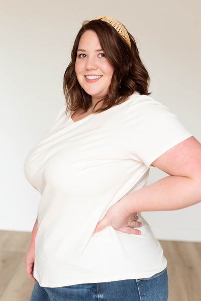 Side view of a plus size cream ribbed top