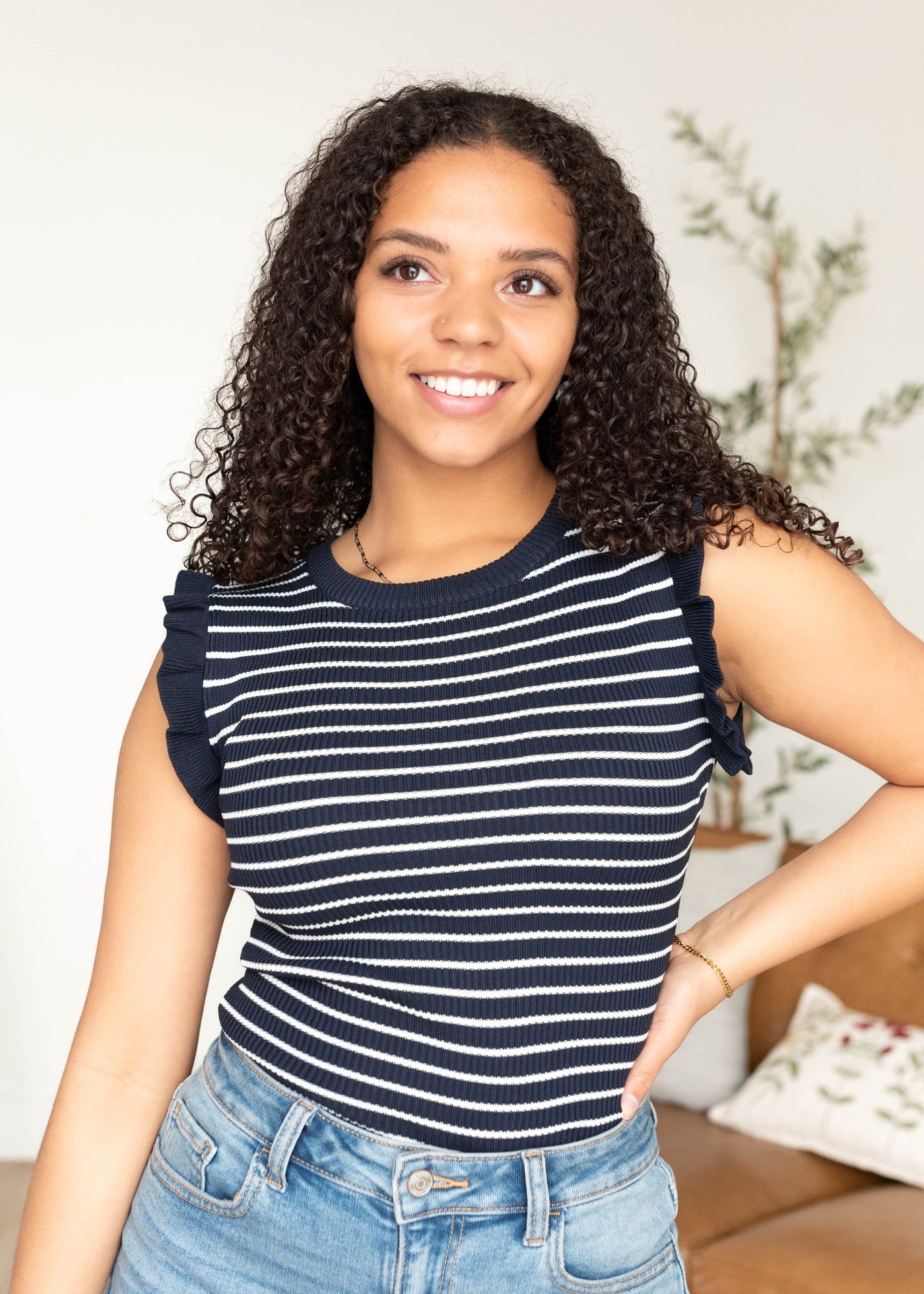 Ruffle on the sleeve of the navy sweater vest