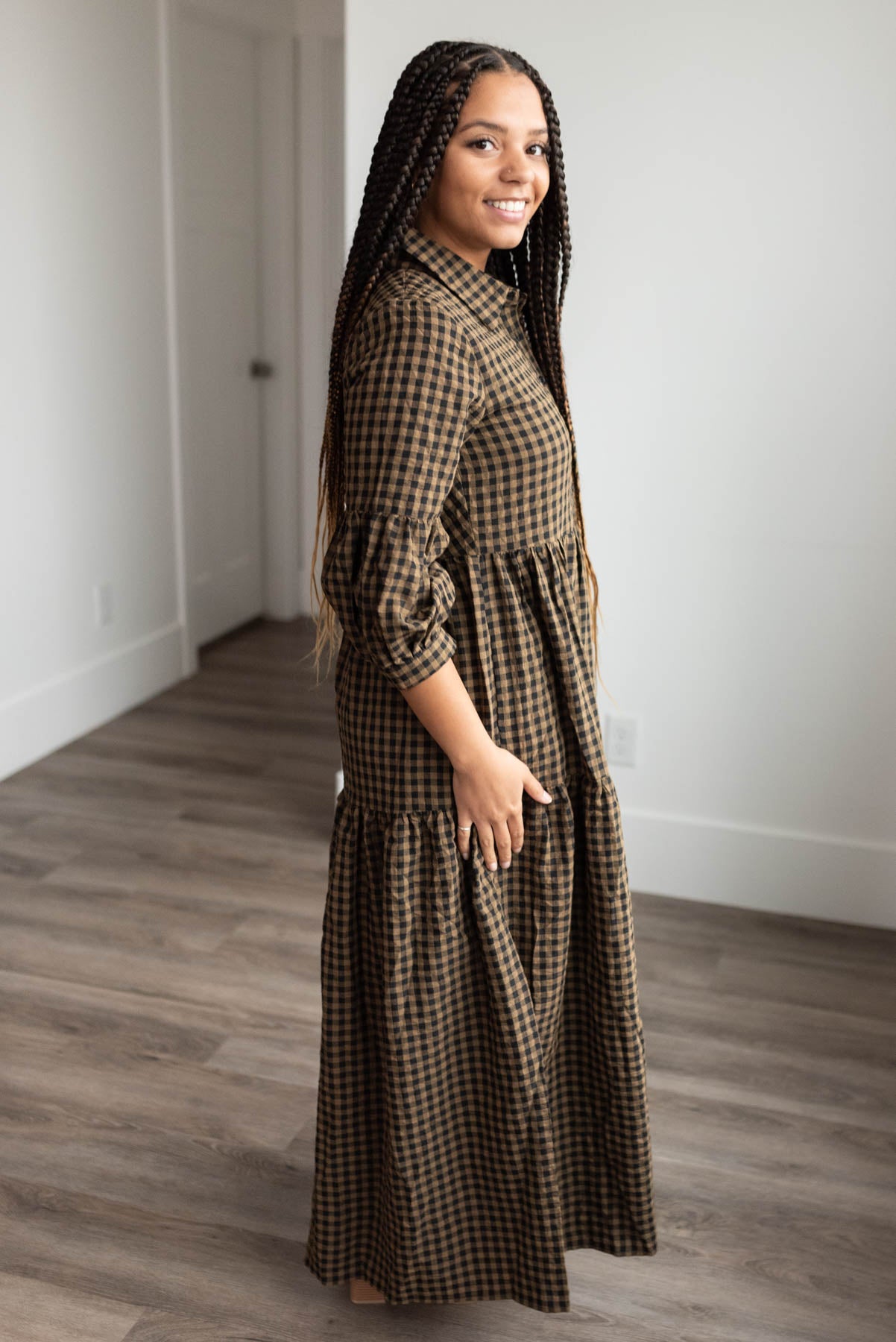 Side view of the the brown gingham tiered dress