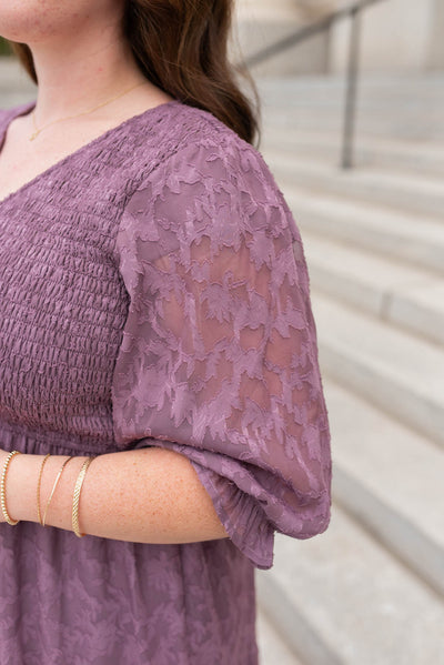 Close up of the sleeve and fabric on the plus size purple floral dress