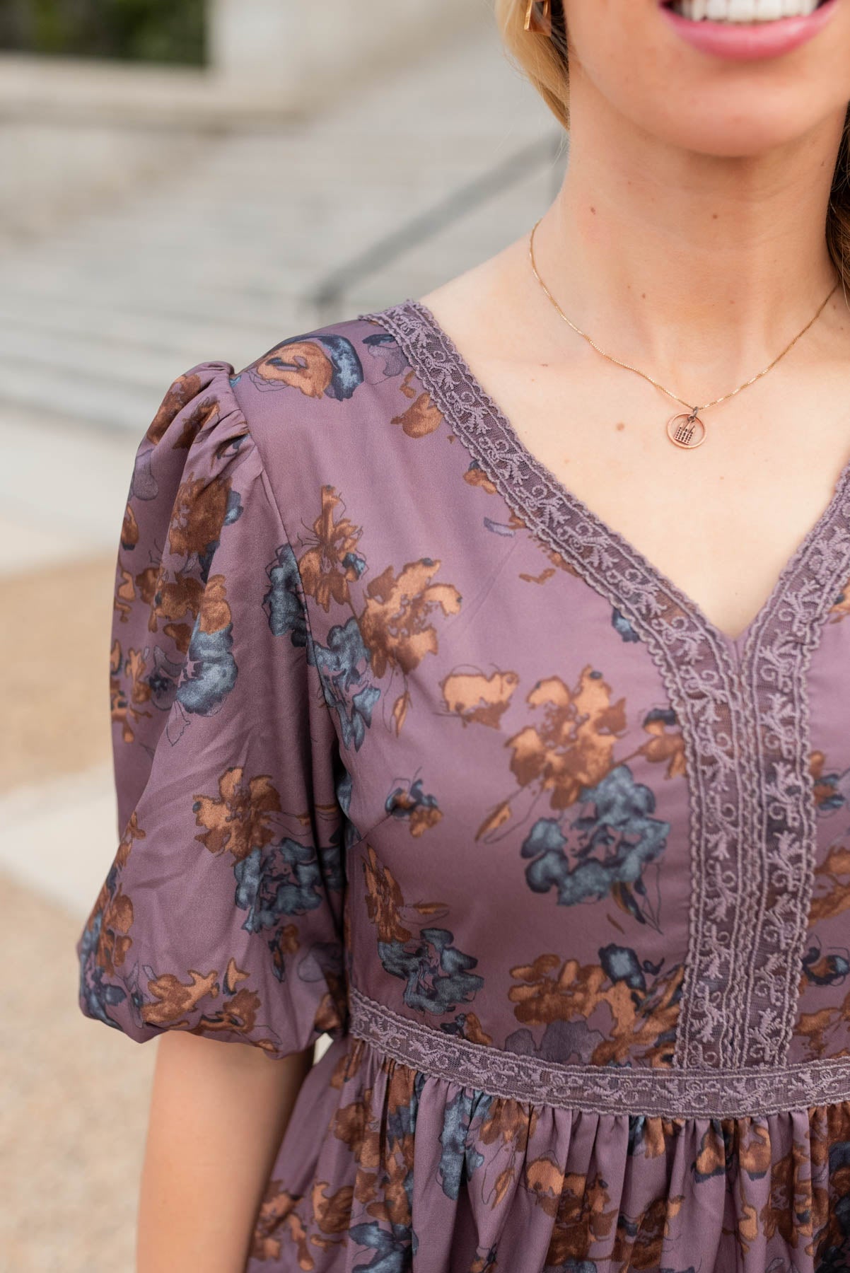 Close up of the fabric and lace on the purple floral tiered dress