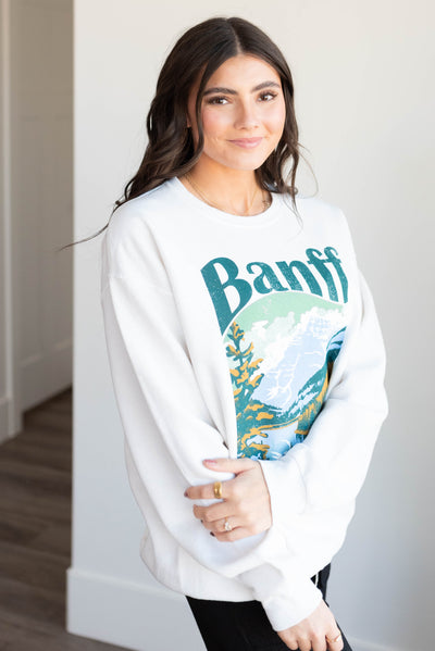 Side view of the white Banff National Park sweatshirt