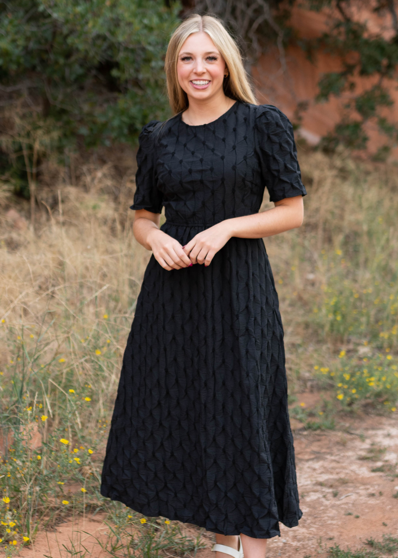 Black dress with short sleeves and pin tuck fabric design