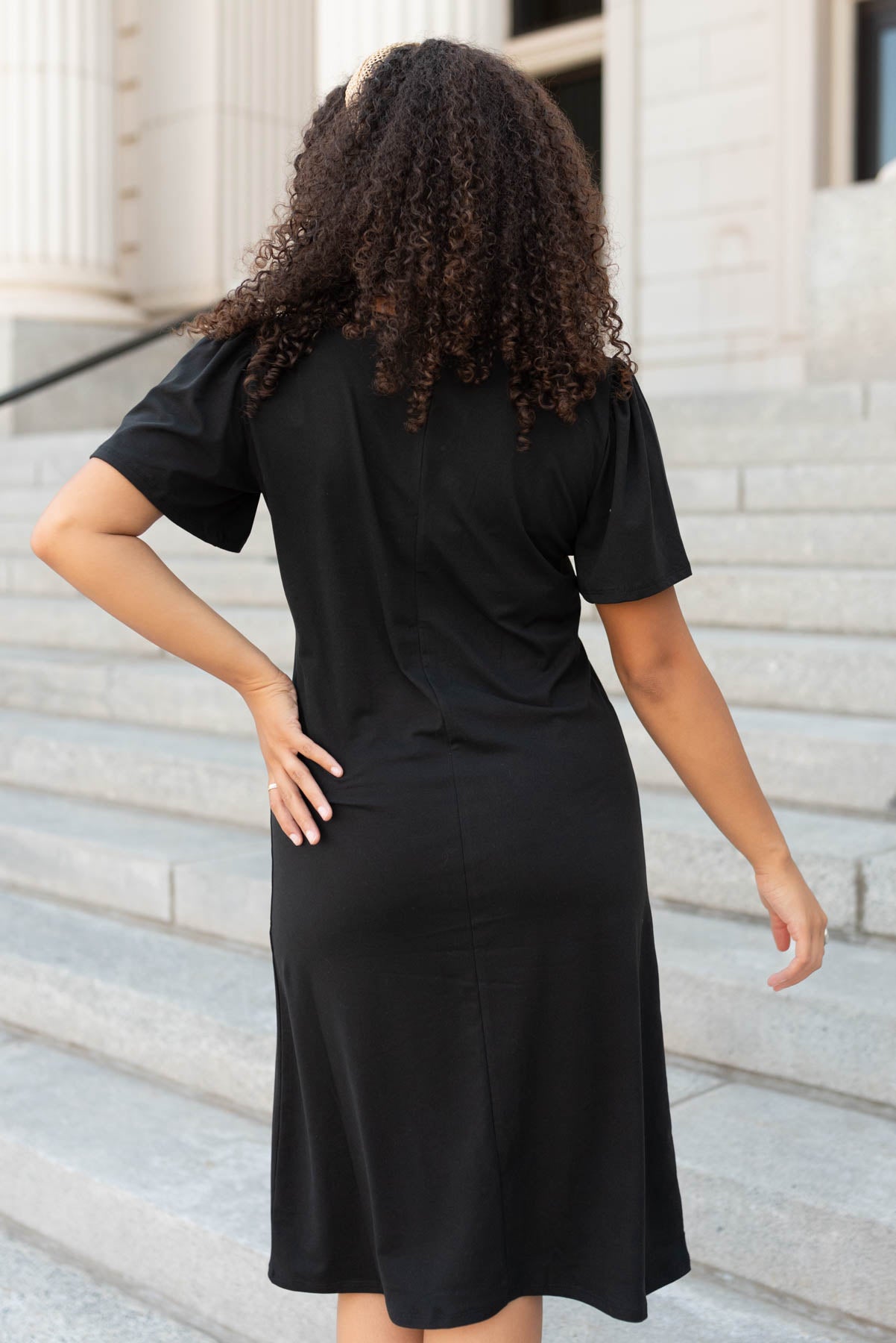 Back view of the black v-neck mini dress