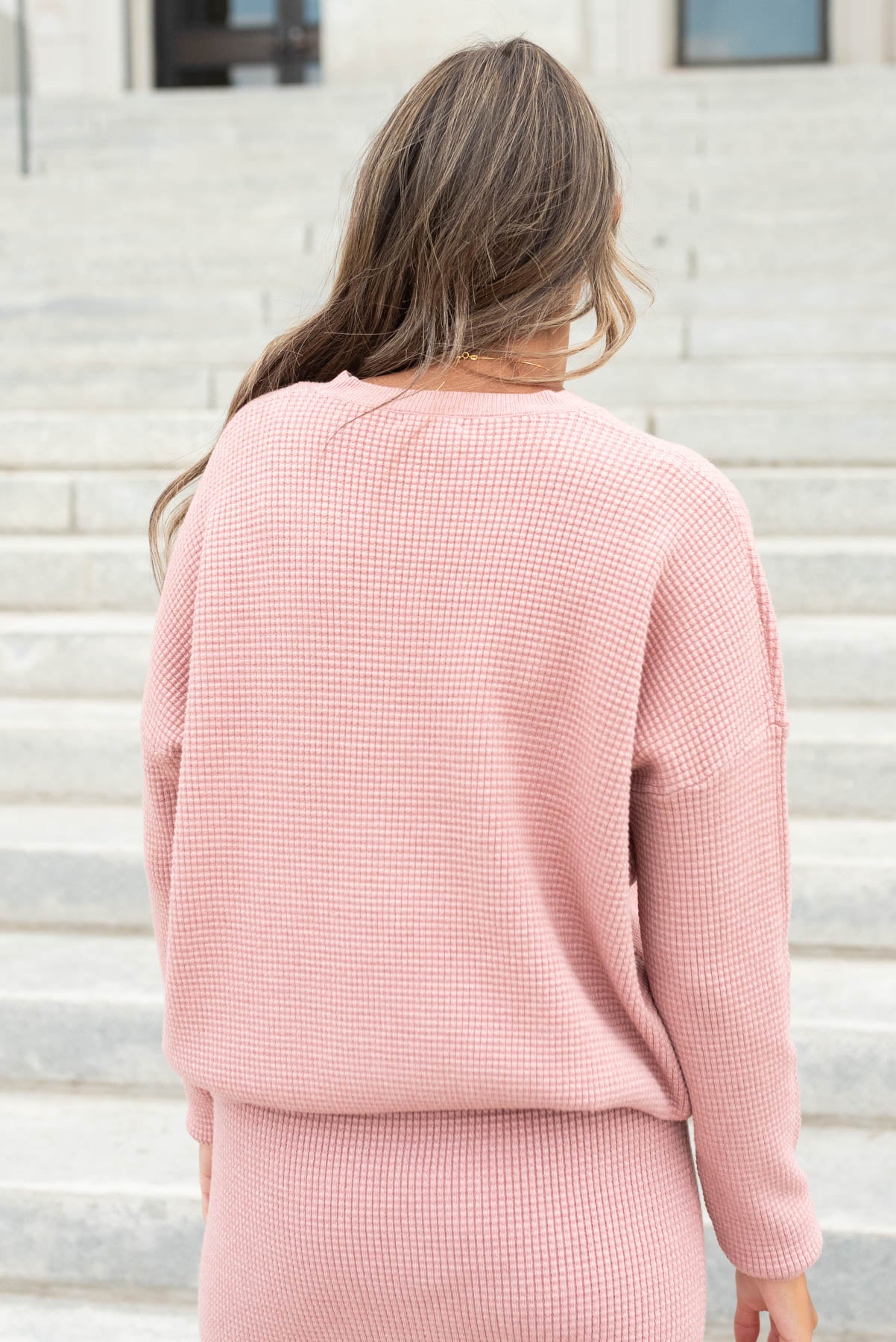 Back view of the blush pink sweater