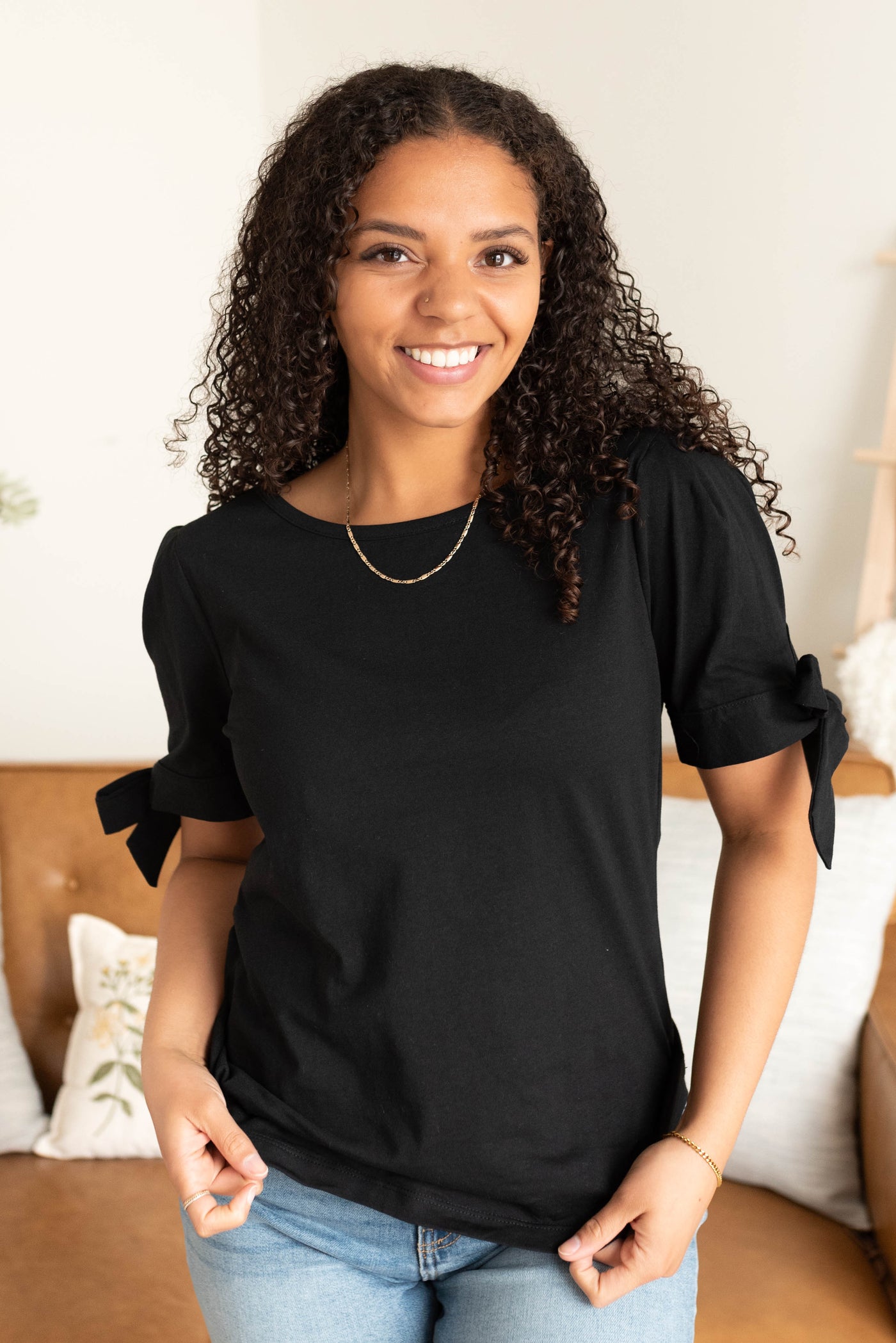 Black bow top with short sleeves and the bow on the cuff