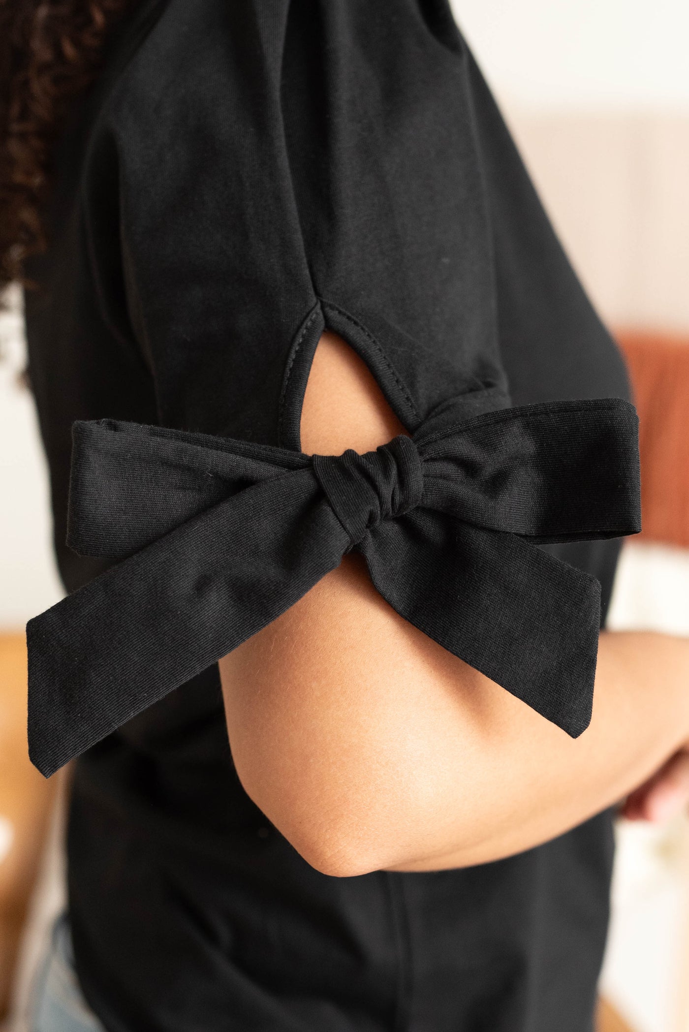 Close up of the sleeve on the black bow top