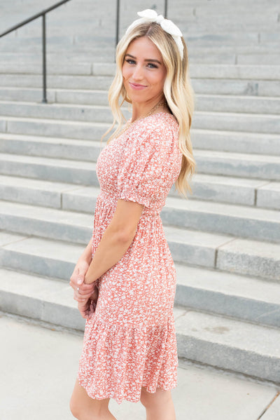 Side view of the short sleeve coral floral mini dress