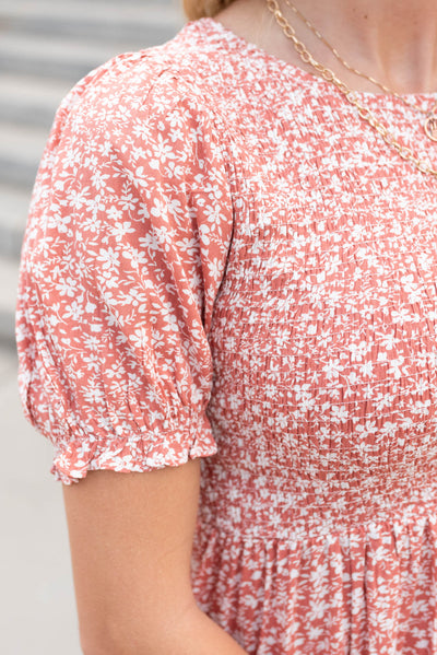 Close up of the sleeve and fabric on the coral floral mini dress