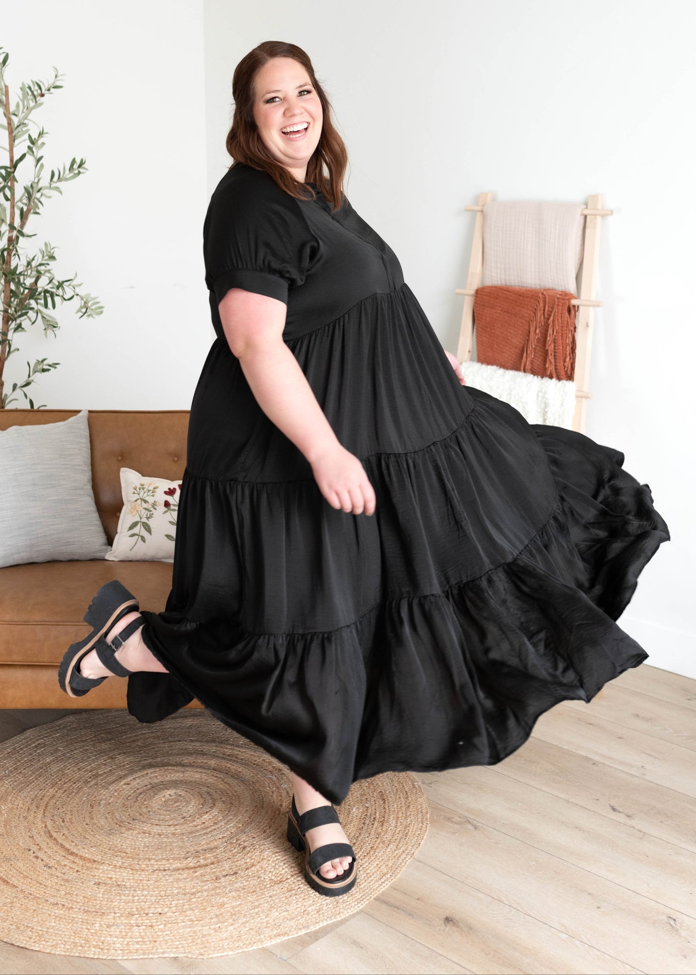 Side view of the black satin dress in plus size