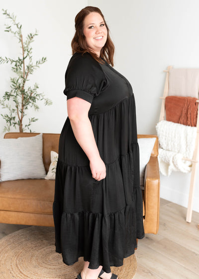 Side view of the plus size black satin dress