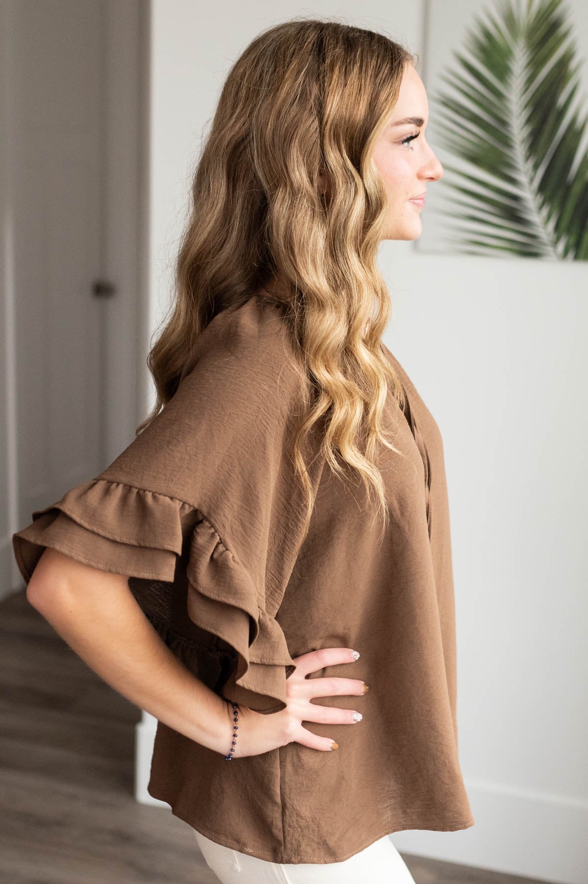 Side view of the cocoa ruffle sleeve blouse