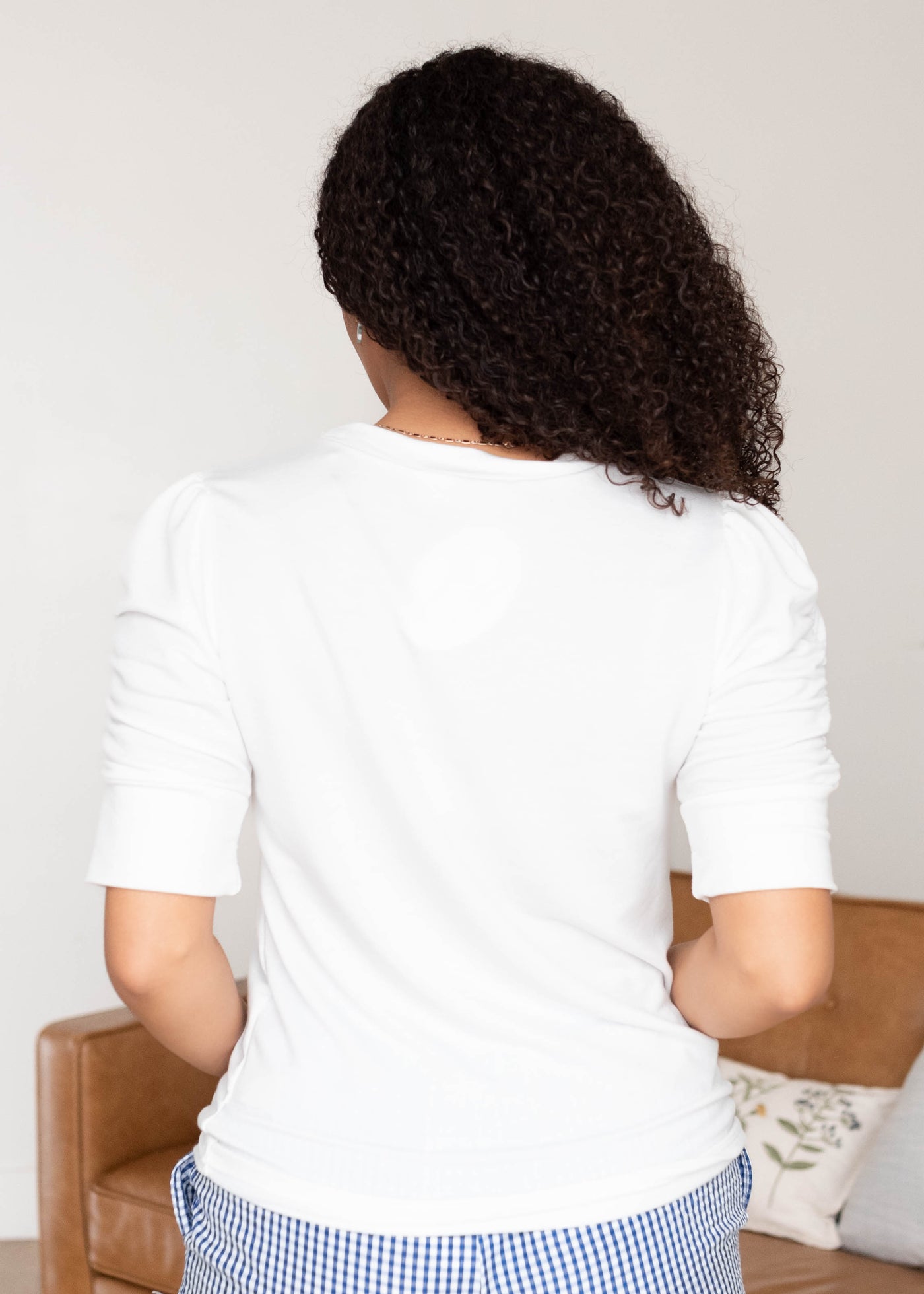 Back view of the ivory ruffle sleeve top