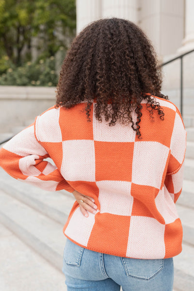 Back view of the rust checker sweater