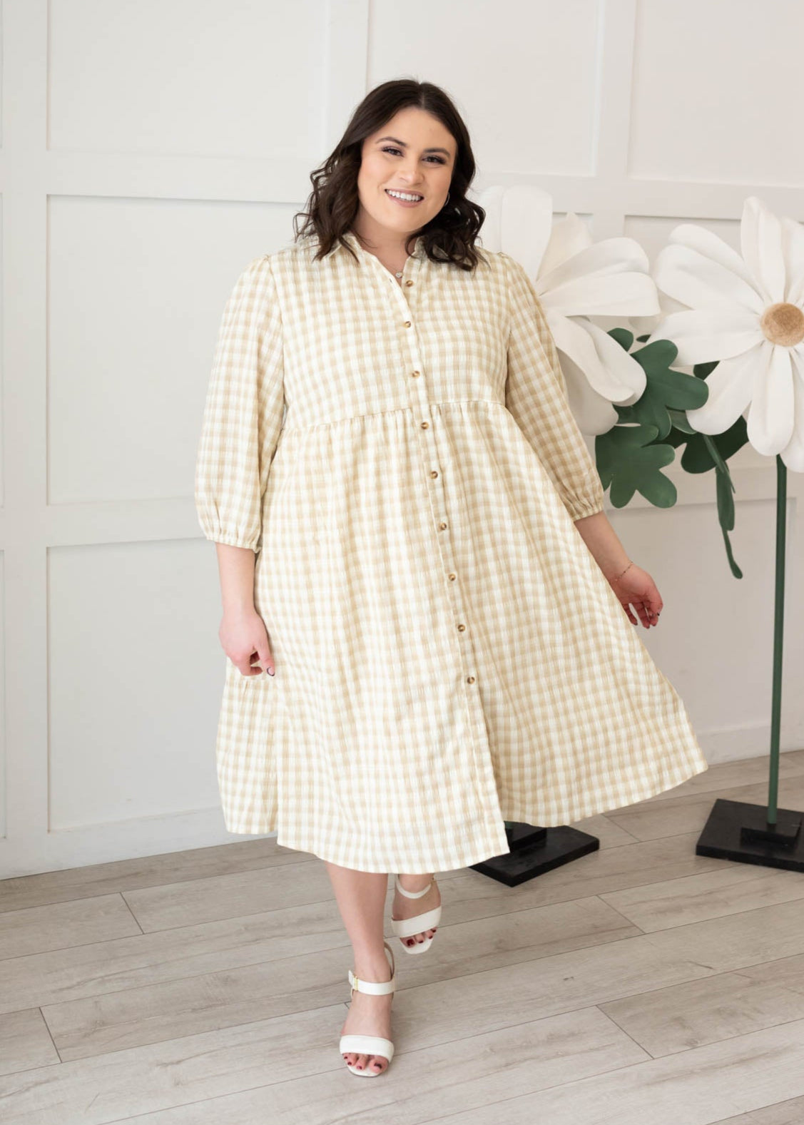 Three quarter sleeves on the plus size taupe gingham button down dress