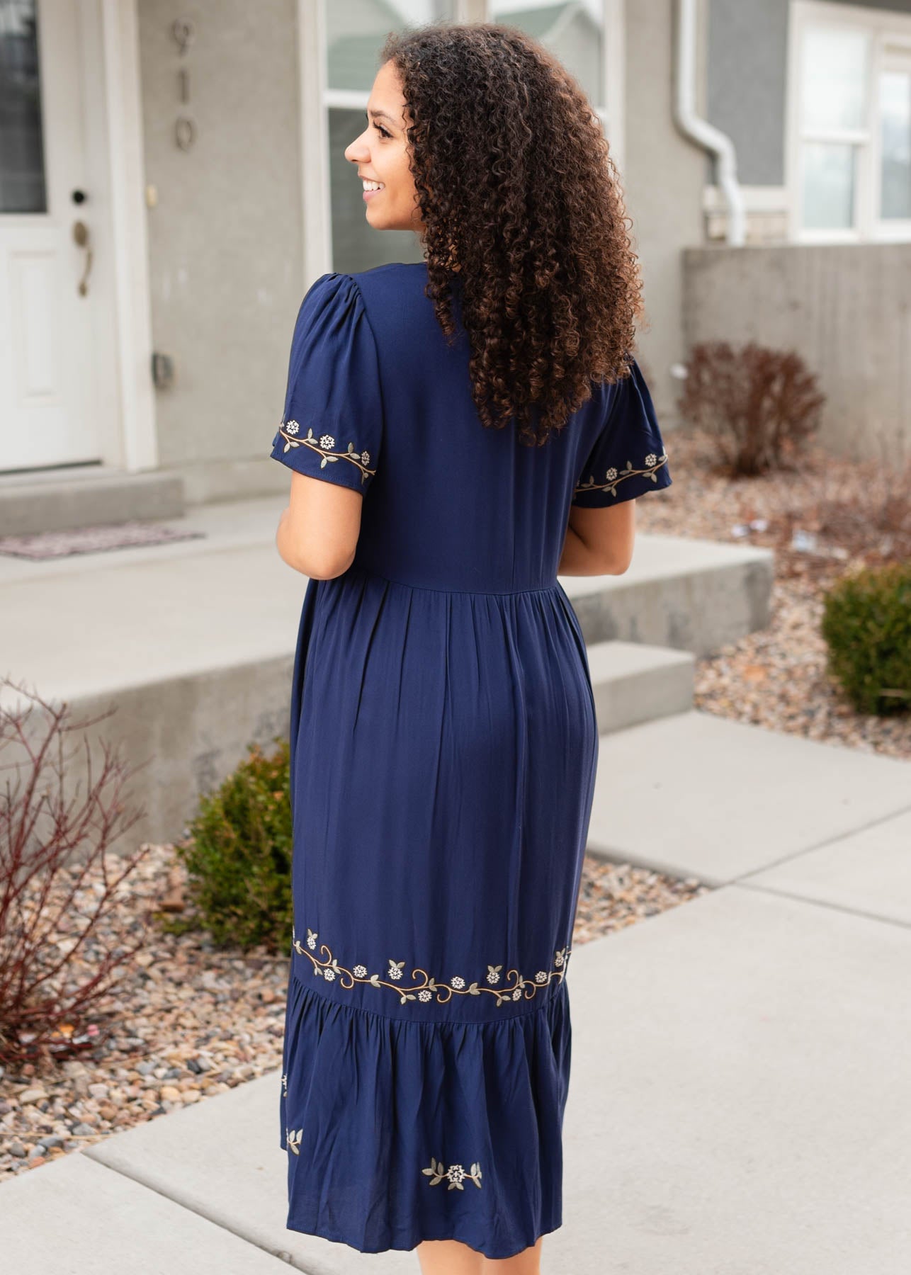 Side view of the navy embroidered dress