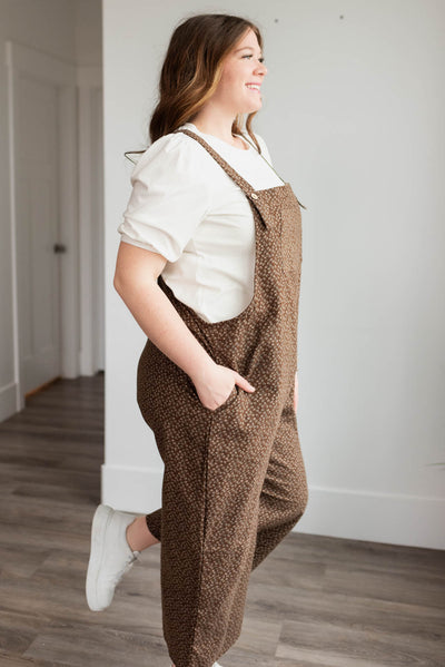 Side view of the plus szie brown floral printed overalls