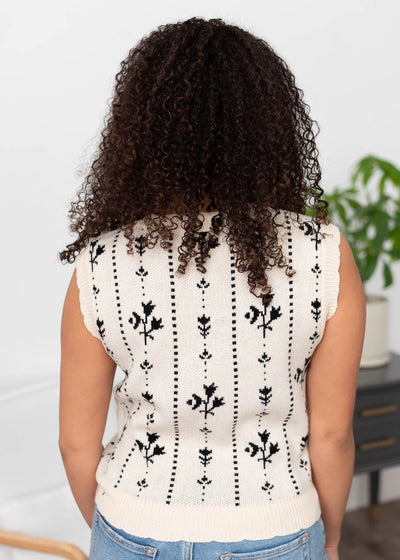 Back view of the black floral sweater vest