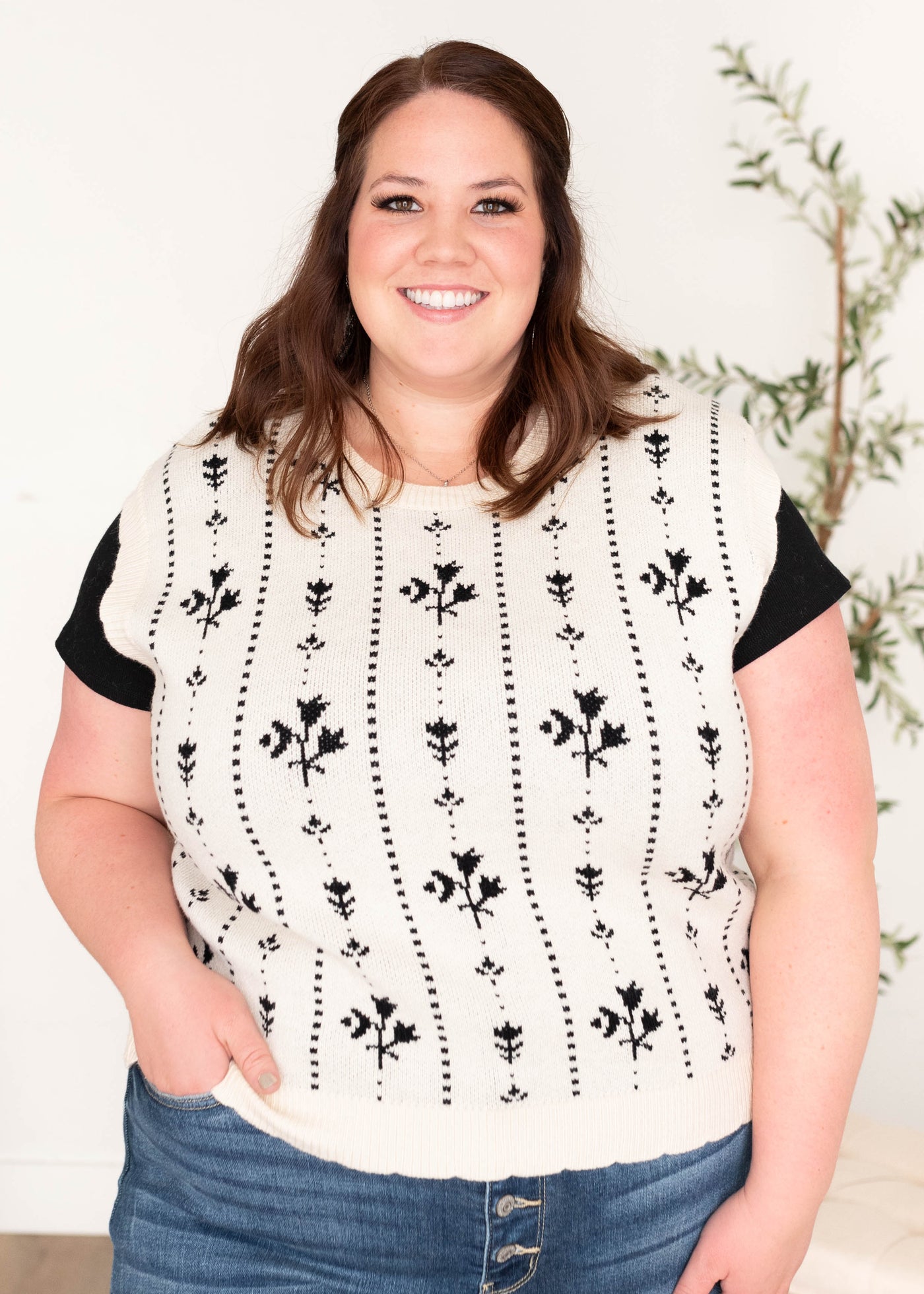 Sleeveless black floral sweater vest in plus size