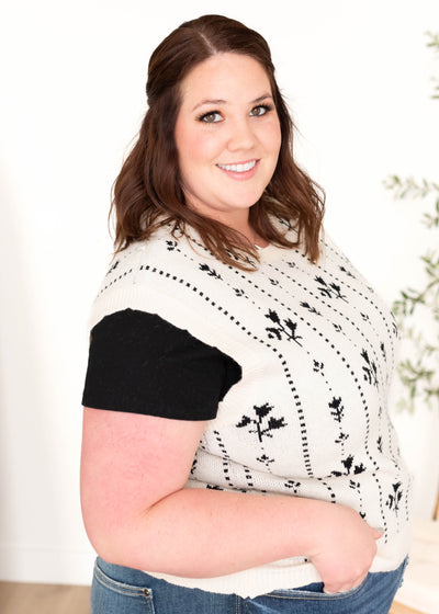 Side view of the black floral sweater vest in plus size