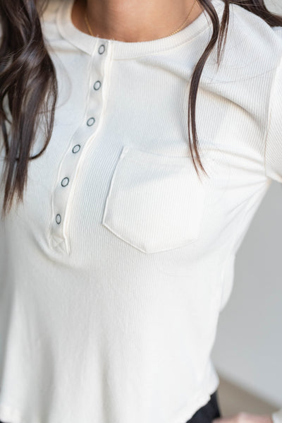 Close up of the cream long sleeve top