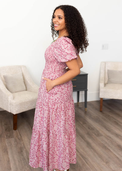 Side view of the blush floral tiered dress with pockets