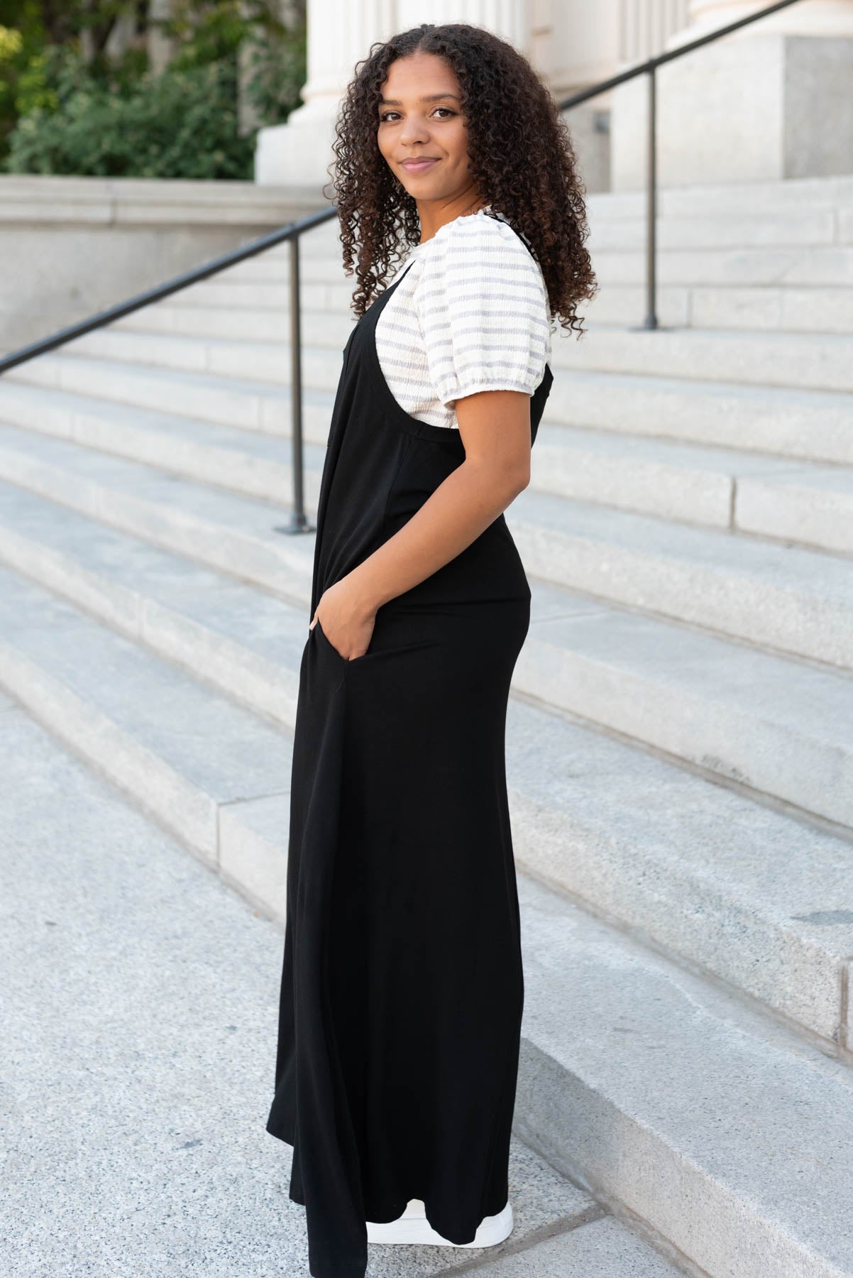 Side view of the black overall maxi dress