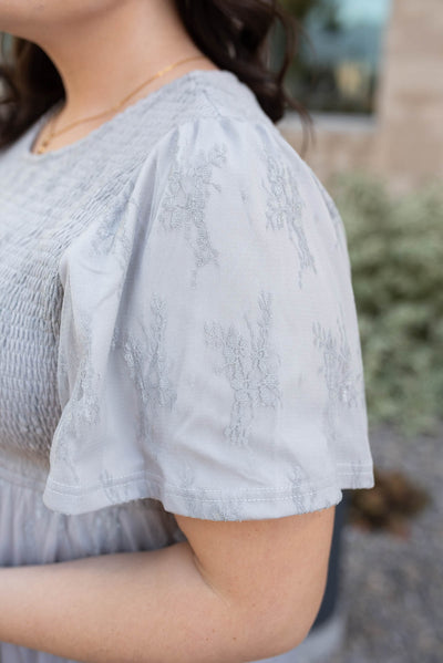 Close up of the sleeve on the plus size grey floral lace dress