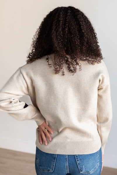 Back view of the khaki black floral sweater